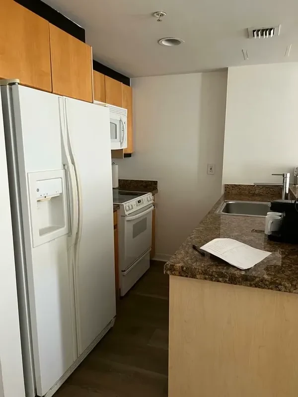 Before — Bentley Hotel South Beach kitchenette with LED strip and dated finishes