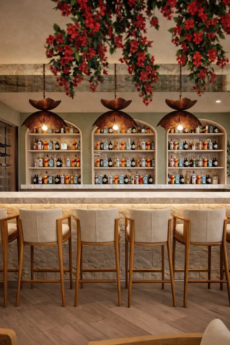 Luxury bar interior design South Beach Miami — three arched back-lit spirit display shelves with warm oak framing, copper flower-shaped pendant lights, dramatic cascading red bougainvillea ceiling installation and cream linen upholstered bar stools, IV Atelier Brisa Casa restaurant Ocean Drive