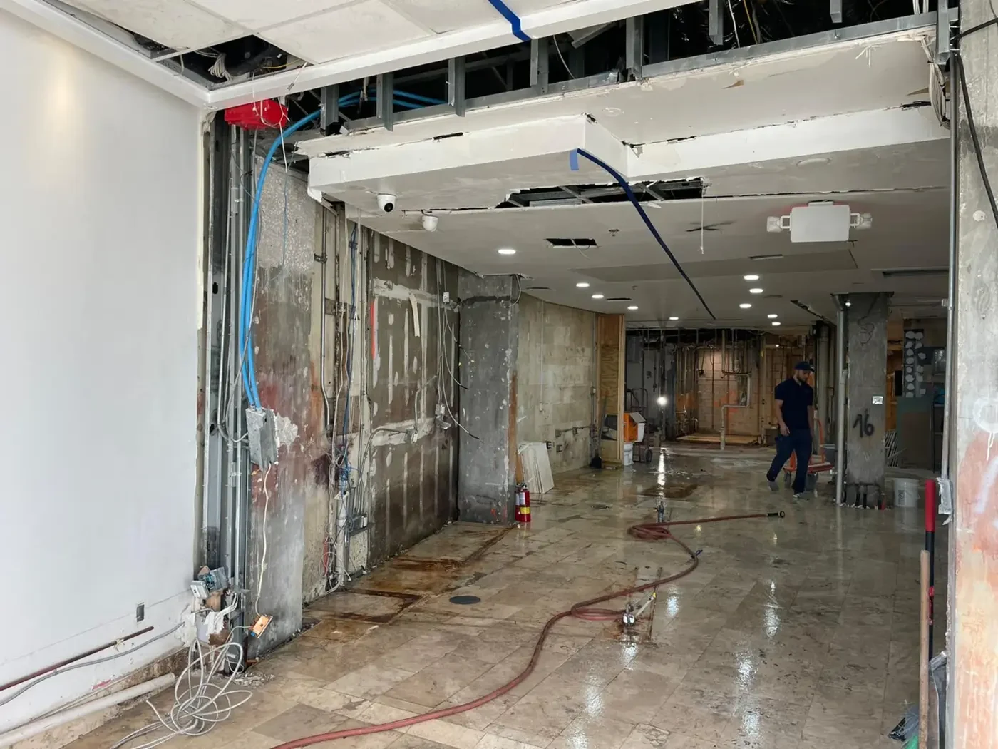 Before renovation photo of the Ocean Drive, Miami South Beach hospitality space later designed as Brisa Casa by IV Atelier, with open framing, removed finishes, and active construction work area.