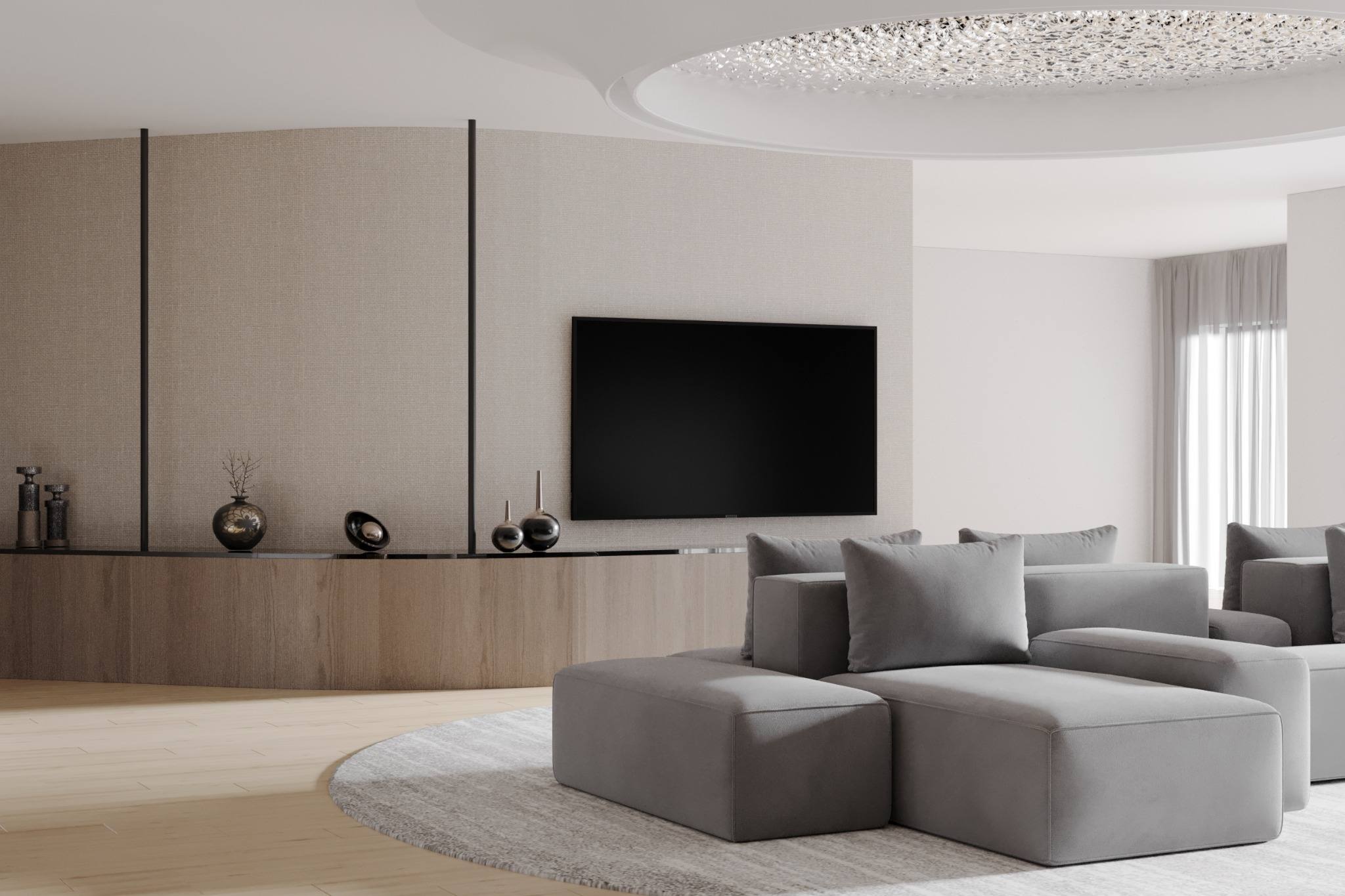 Fisher Island residence living lounge — low-profile modular sofas, long oak media console, textured wall panels with thin black reveals, circular rug, and soft indirect ceiling detail in a bright luxury interior by IV Atelier