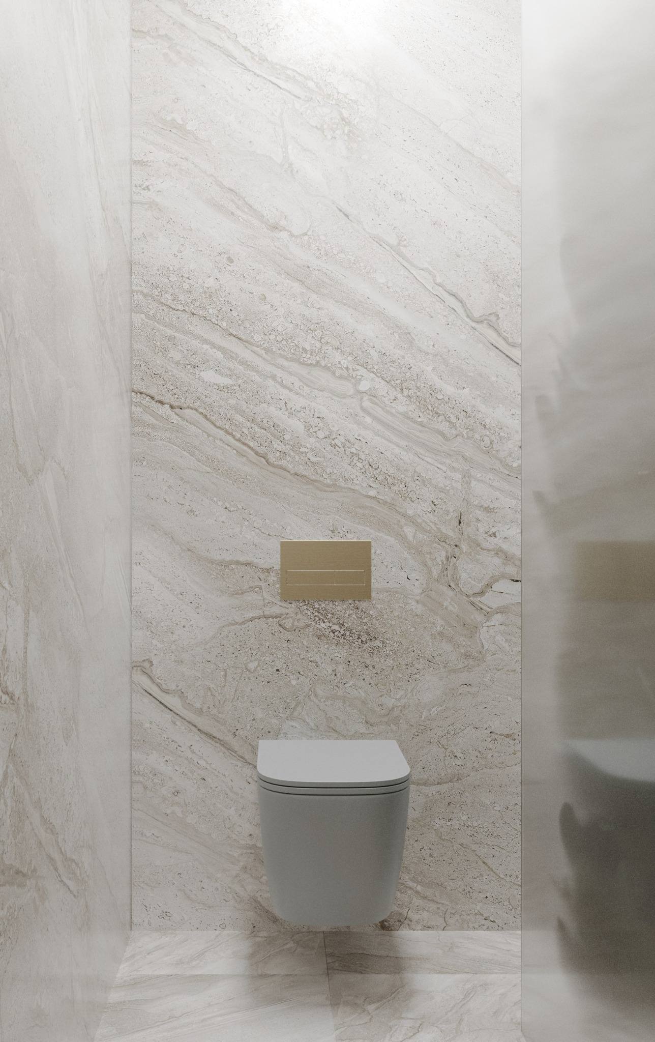 Fisher Island residence powder room — minimalist wall-hung toilet centered on a statement stone slab with warm brass flush plate and clean architectural side walls by IV Atelier