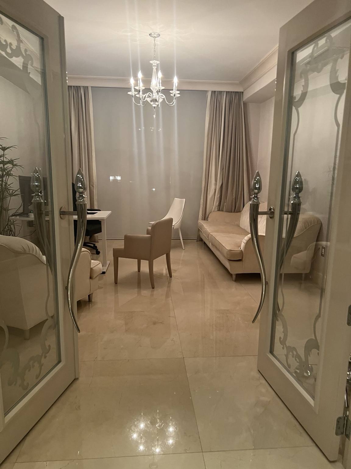 Before renovation: Fisher Island residence entry view into sitting room — original finishes and lighting conditions prior to IV Atelier redesign