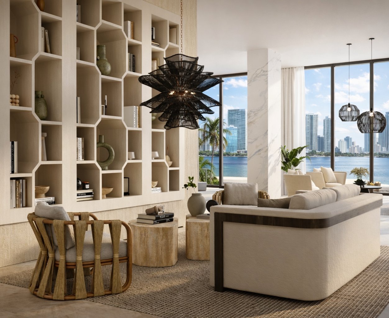 IV Atelier luxury interior design — Miami waterfront living room with sculptural honeycomb bookcase, rattan pendant lighting, travertine coffee tables and panoramic bay views, designed by Irena Viitiuk