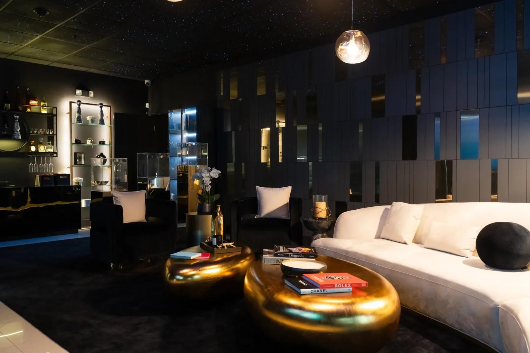 Luxzen lounge — white sofa with black round cushions and gold coffee tables.