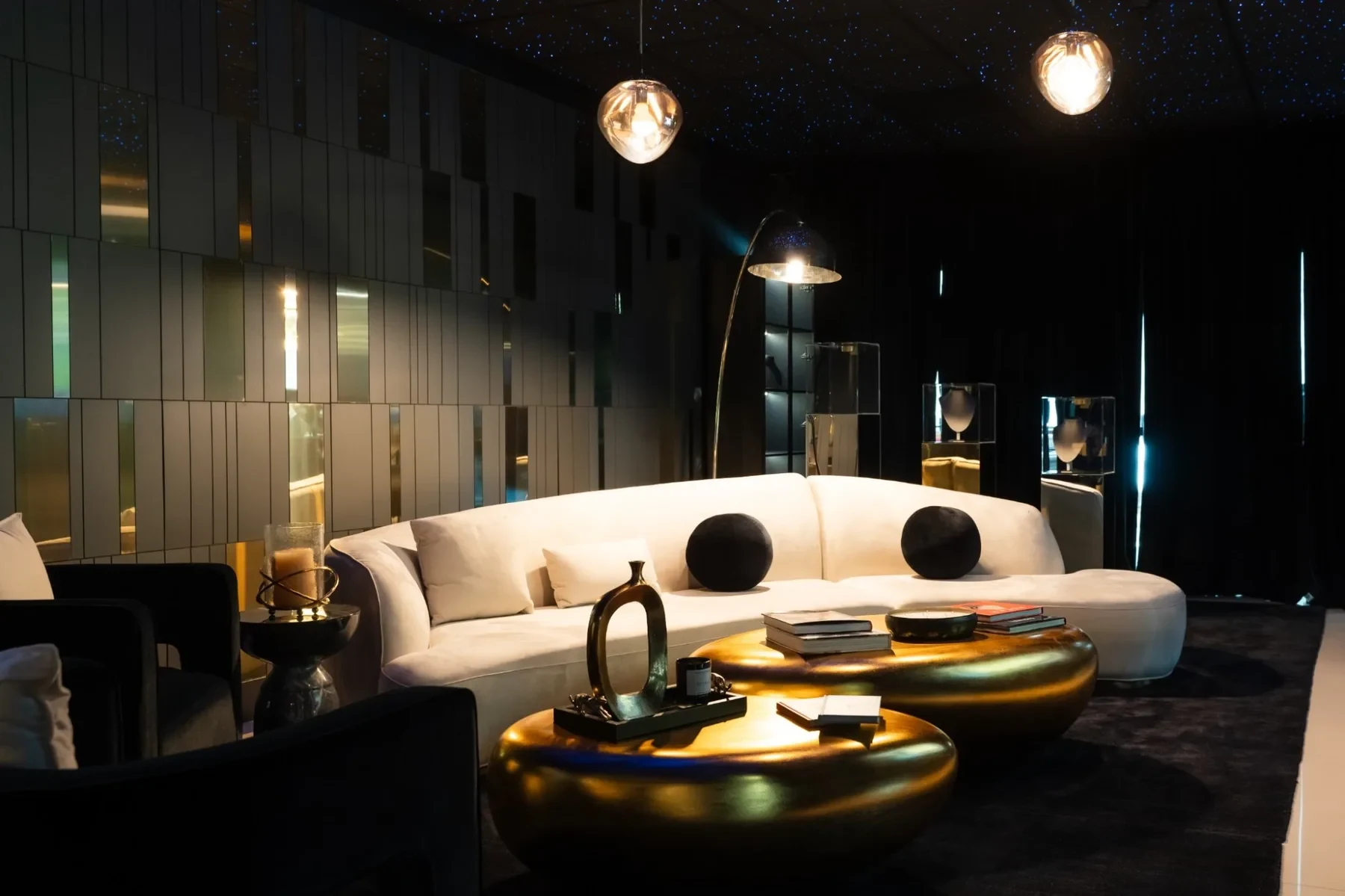 Luxzen lounge — curved sofa, mirrored wall panels and starry ceiling.