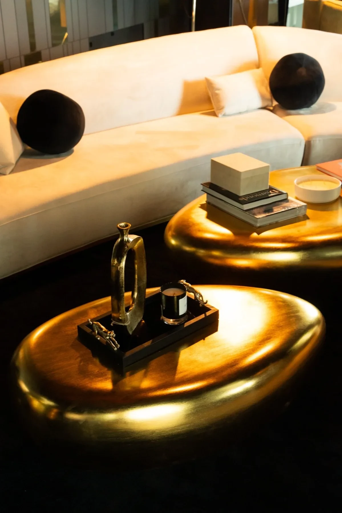 Luxzen gold sculptural coffee tables — organic forms with warm ambient glow.