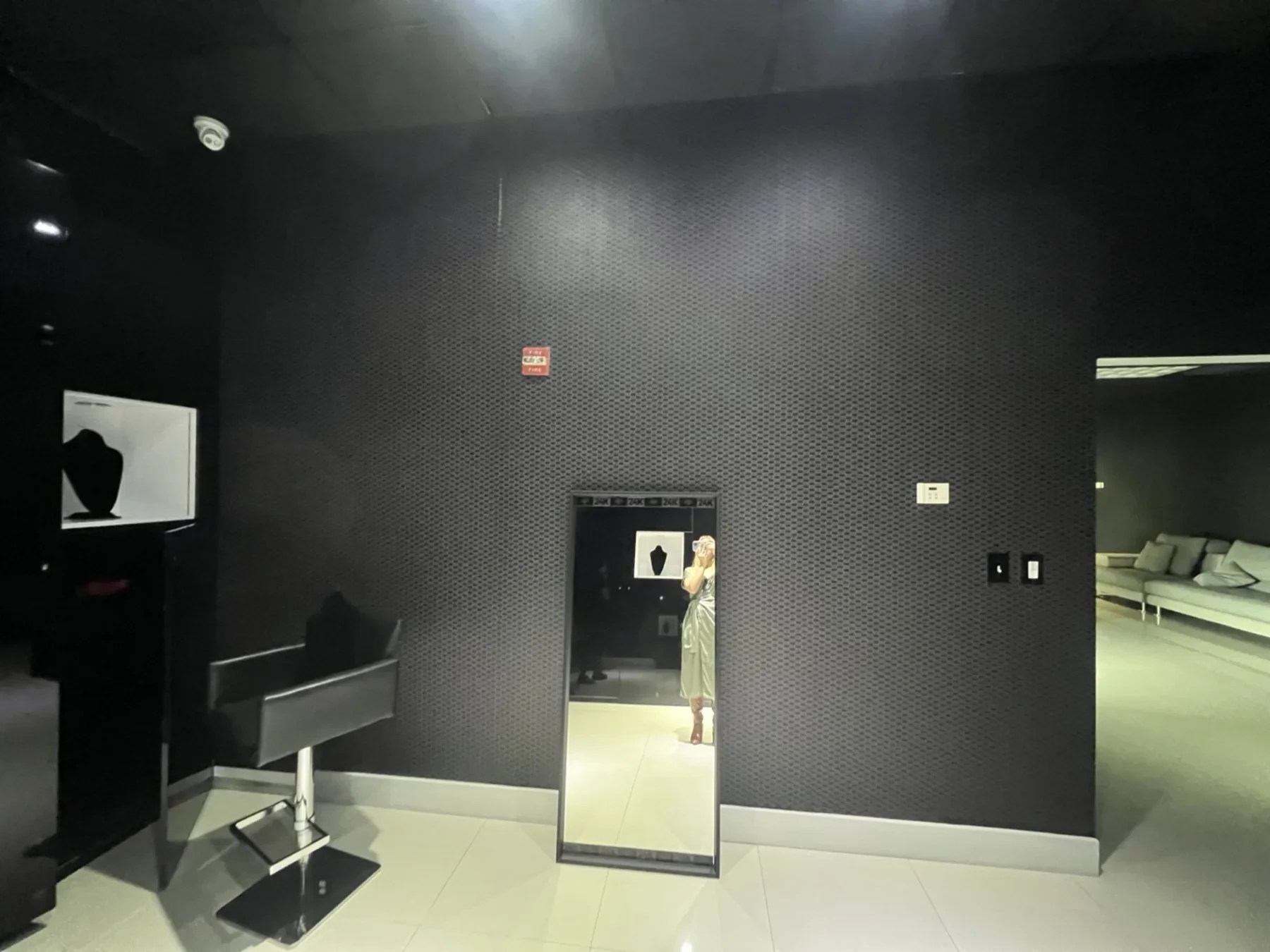 Before — empty wall with barber chair and mirror.