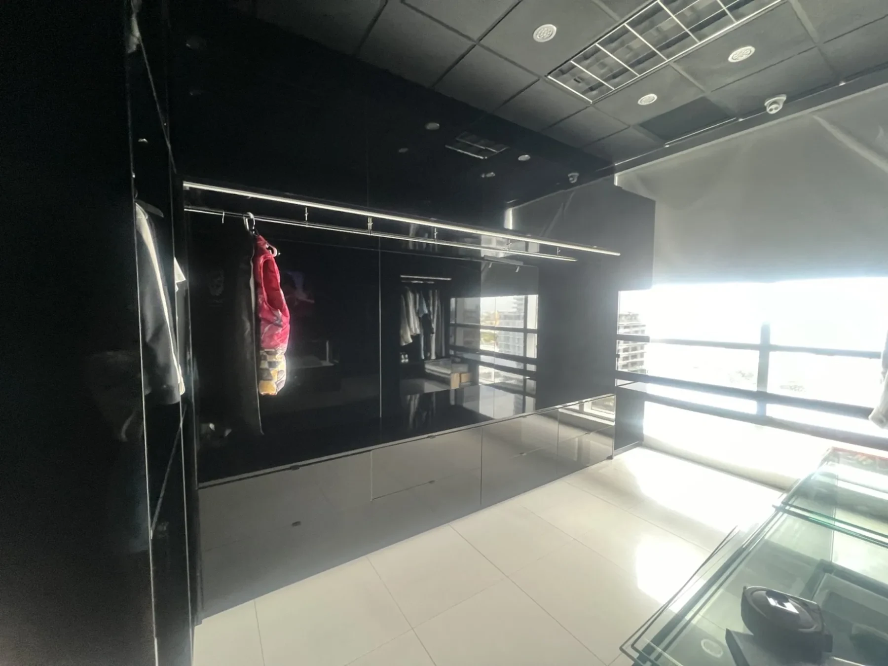 Before — existing space with black cabinetry and city views.