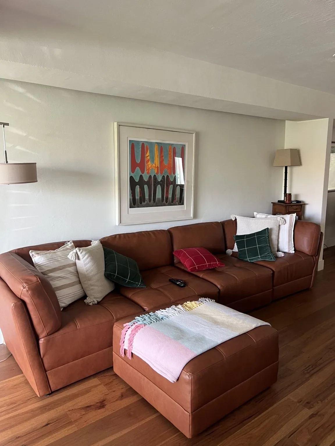 Before — original living room with leather sectional.