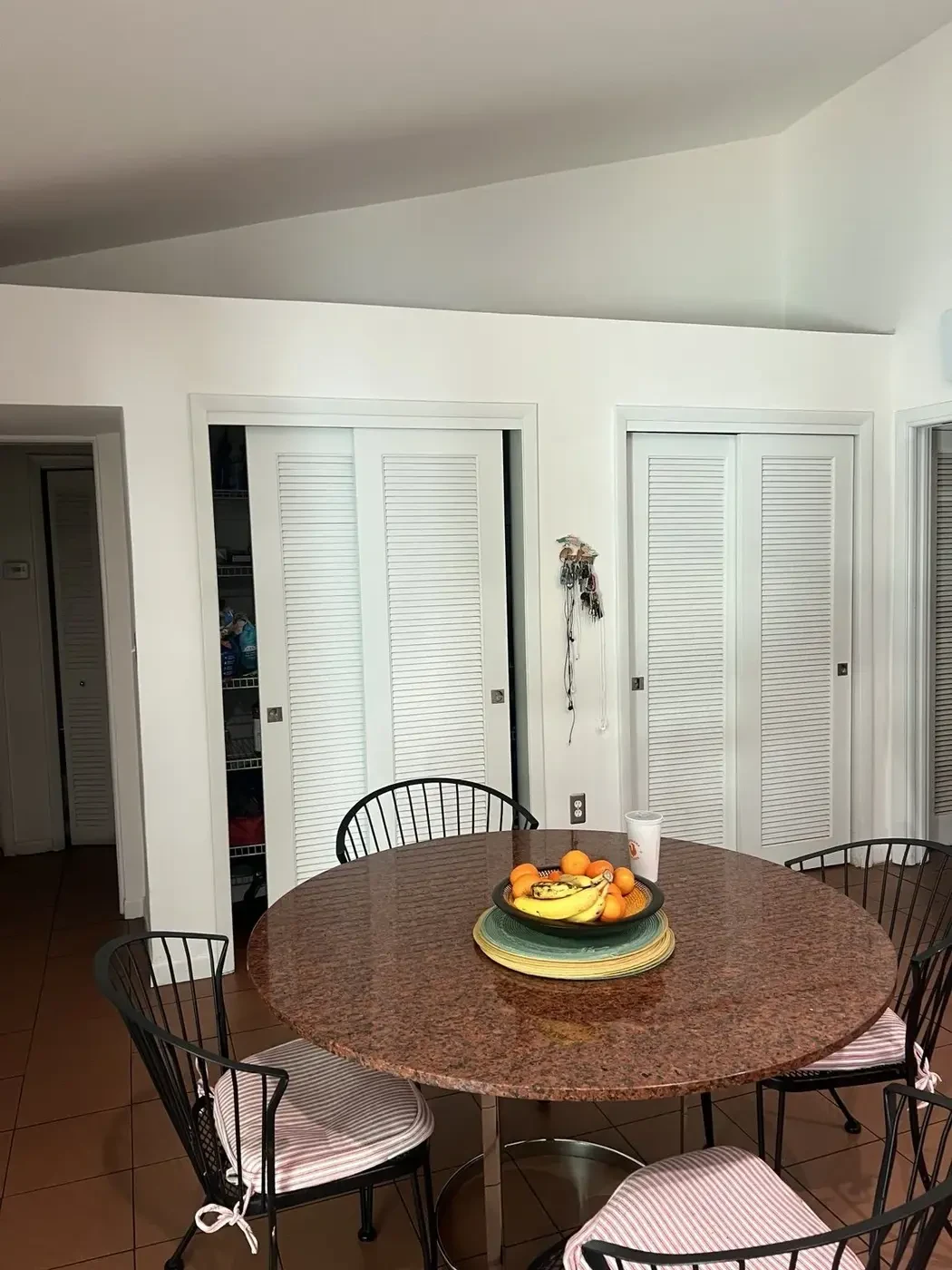 Before — original kitchen with stove and colorful tile backsplash.