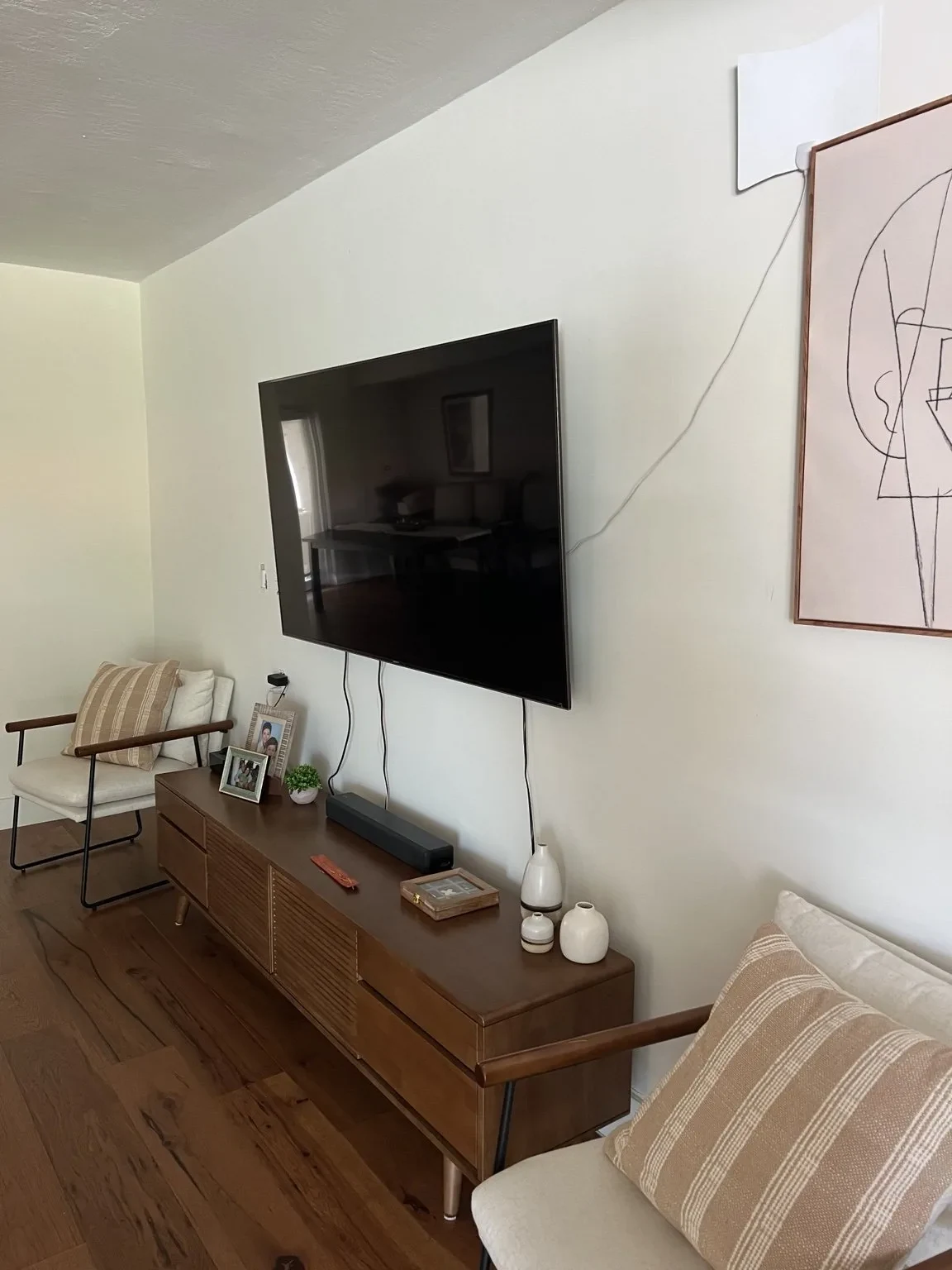 Before — original living room TV wall prior to transformation.